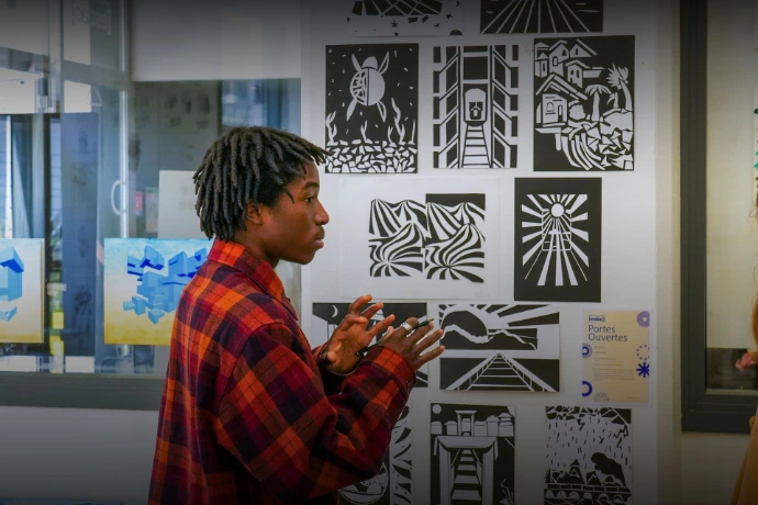 Student presenting his graphic illustrations at an open day
