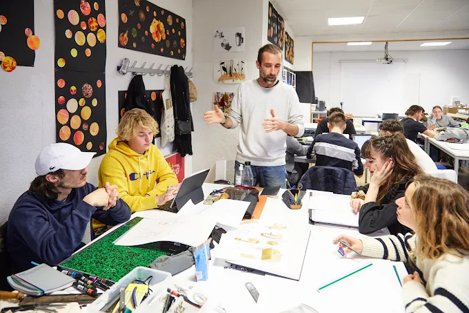 Enseignant animant un cours de design avec des étudiants en atelier au campus ESDAC Aix-en-Provence