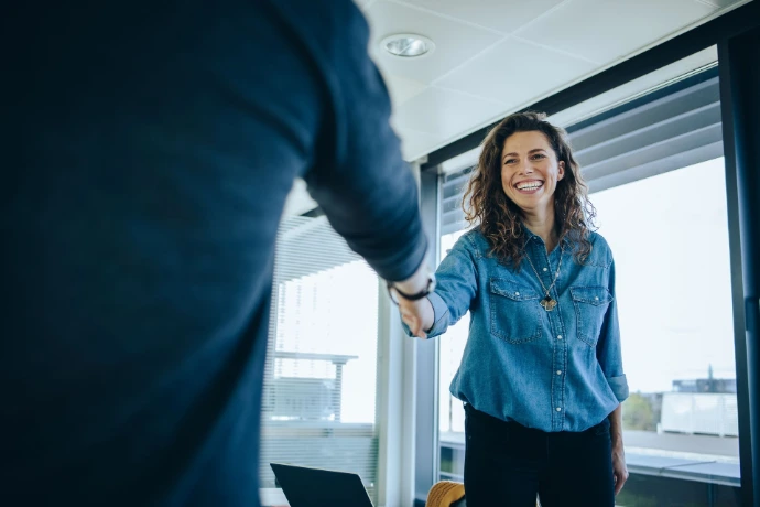 Poignée de main entre deux professionnels dans un cadre de bureau